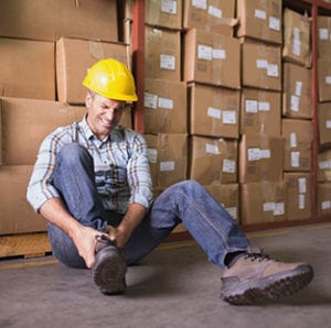 Worker sits on the floor with injured leg