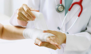 Doctor doing bandage in patient injury