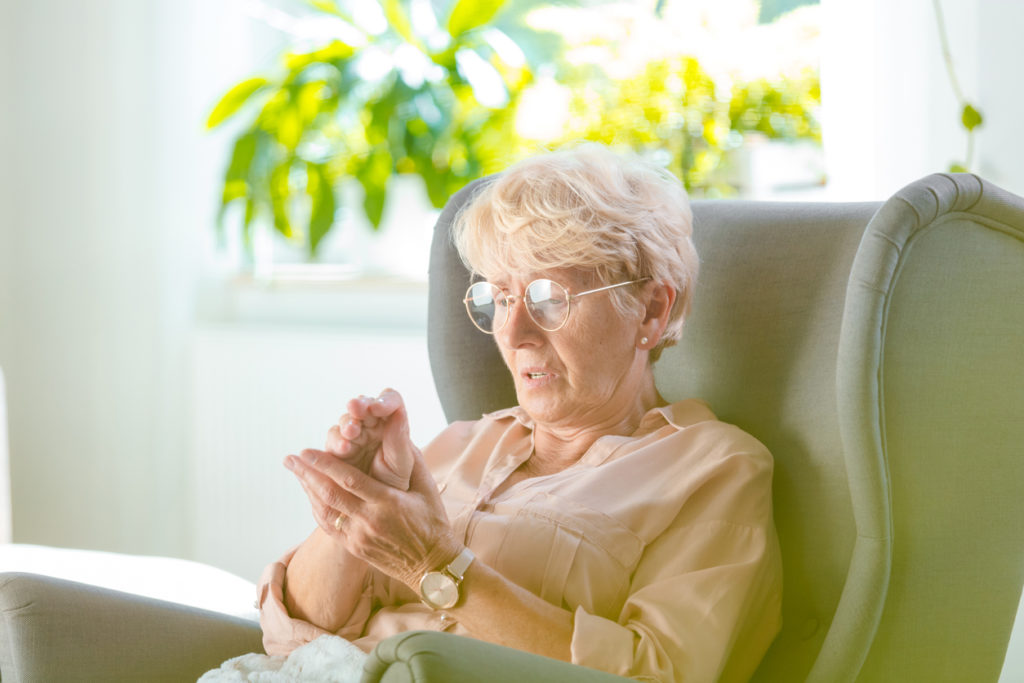 Elderly woman feeling numbness in her hand