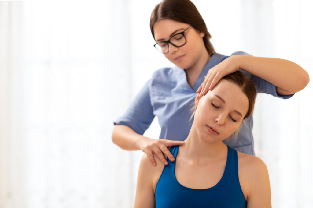 Female physiotherapist or a chiropractor
