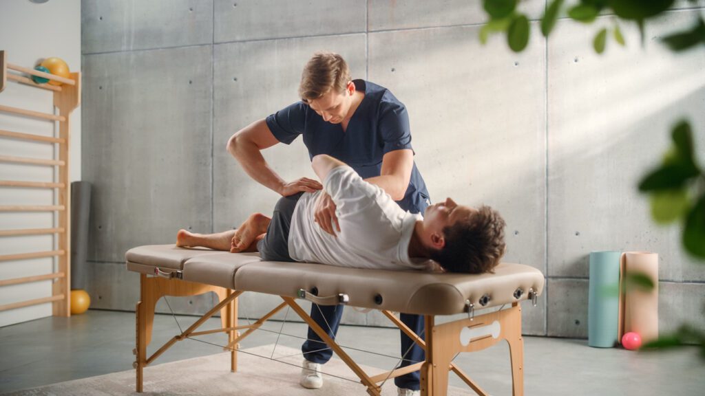 Chiropractor giving therapy for back pain