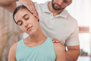 chiropractor treating patient's neck