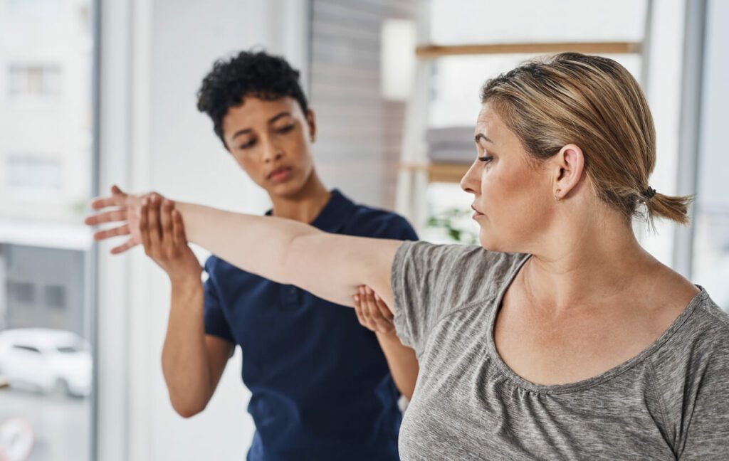 A woman is receiving care from an occupational health specialist.